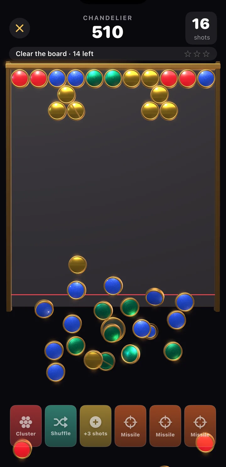 Discbuster on iPhone: a pile of enamel discs with brass rims tumbling off the board after a match